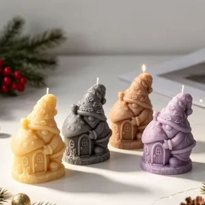 Detailed view of four colorful gnome mushroom house candles with festive Christmas decor.