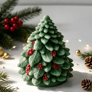 Detailed macro shot of a green Christmas tree candle with red berry decorations.