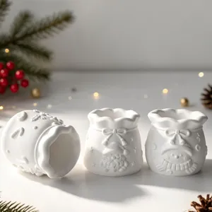 Close-up view of white silicone molds featuring 3D Santa and Snowman relief patterns