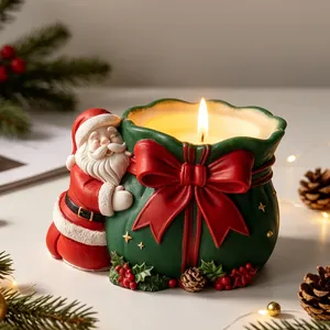 Vue détaillée d'une bougie parfumée Père Noël serrant un sac cadeau vert pour Noël.