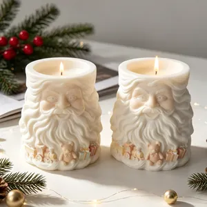 Detail von zwei brennenden Weihnachtsmann-Kerzen mit festlicher Dekoration