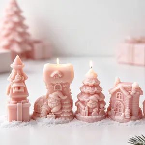 Pink Christmas-themed candles in festive shapes like Santa and trees on artificial snow.