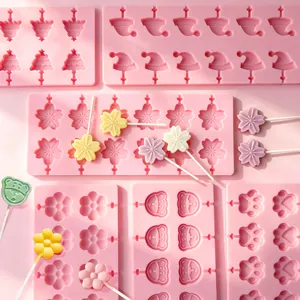 Detail of pink silicone lollipop molds with Sakura, Christmas tree, and paw shapes.