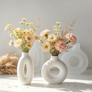 Detail view of modern oval and circular donut vase silicone molds with finished vases