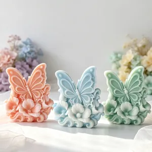 Detailed macro view of 3D butterfly floral relief aromatherapy candles in pastel colors.