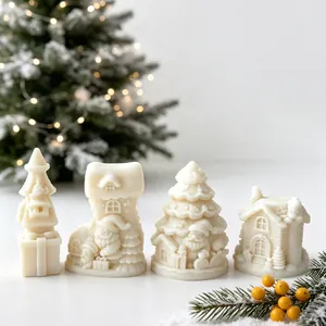 Detailed view of four white Christmas-themed scented candles with intricate holiday motifs