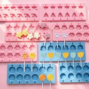 Detailed view of assorted cartoon silicone lollipop molds with handmade finished candies