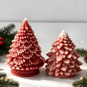 Detailed macro view of two ornate Christmas tree candles with delicate snow texture