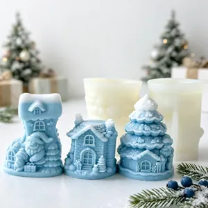 Silicone molds for Christmas Santa and tree candles shown with finished blue candles