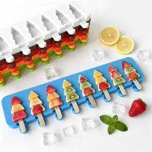 Close-up of vibrant Christmas tree fruit popsicles in a blue 8-cavity silicone mold.