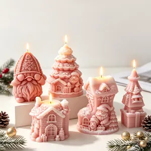 Detailed view of pink Christmas scented candles in gnome, tree, and house shapes.