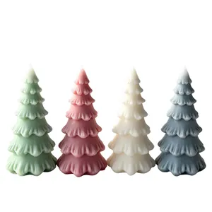 Set of four colorful Christmas tree shaped scented candles for festive holiday home decor