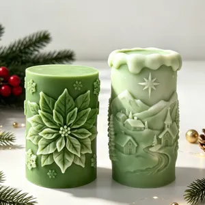 Detailed macro view of embossed Christmas poinsettia and snowy village candle designs