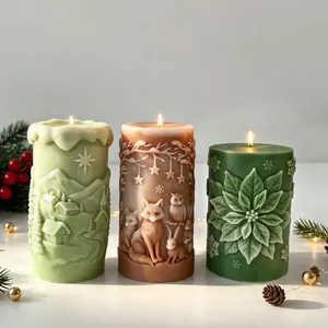 Detailed view of three intricately carved Christmas relief scented candles with warm flames.