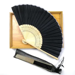 Elegant black folding bamboo fan set displayed with a matching mesh drawstring pouch