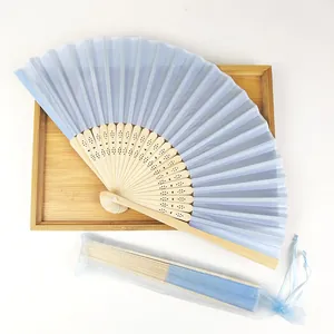 Detail of light blue silk folding fan with bamboo ribs and matching organza pouch