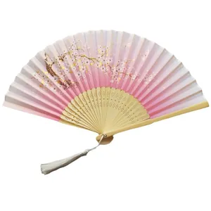 Elegant pink cherry blossom folding fan with natural bamboo ribs and a white tassel.