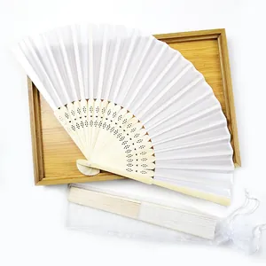 Detailed view of a white silk folding fan with bamboo ribs and white organza gift bag