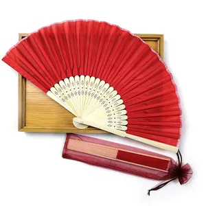 Red fabric folding fan with natural bamboo ribs and matching organza gift bag for weddings.