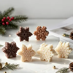 Detailed view of intricate snowflake-shaped scented candles in neutral colors