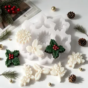 Detail of Christmas holly leaf and snowflake candle silicone mold with finished wax samples