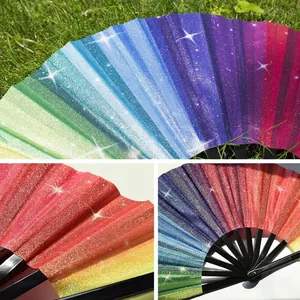 Macro detail view of vibrant rainbow glitter folding fan with black plastic ribs.
