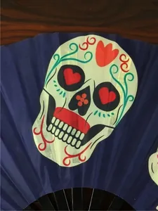 High-quality detail of traditional sugar skull print on a 33cm blue folding fan