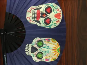 Detail view of blue Kung Fu folding fan featuring colorful Mexican sugar skull prints
