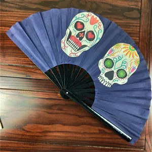 Close-up detail of the vibrant sugar skull print on a 33cm dark blue folding fan
