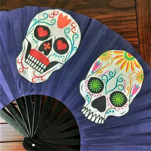 Macro detail of a navy blue Kung Fu folding fan featuring vibrant Mexican sugar skull art