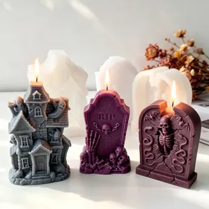 Detail view of Halloween silicone molds with finished haunted house and tombstone candles