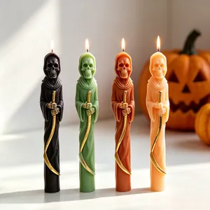 Detailed macro view of four colorful lit Grim Reaper candles for Halloween home decoration