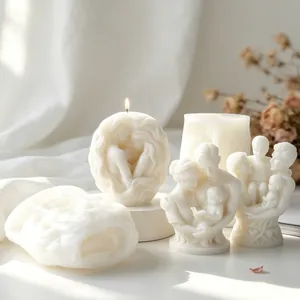Detailed view of family portrait candle mold and finished white wax sculpture candles