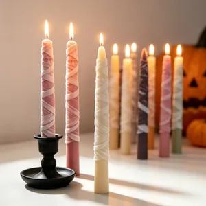 Close-up of lit mummy-themed candles with realistic bandage texture for Halloween decor