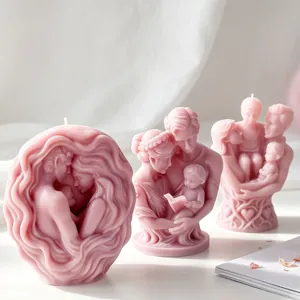 Detailed view of artistic pink 3D family portrait sculpture candles for home decor.