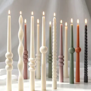 Detailed view of assorted textured and spiral long taper candles in muted colors