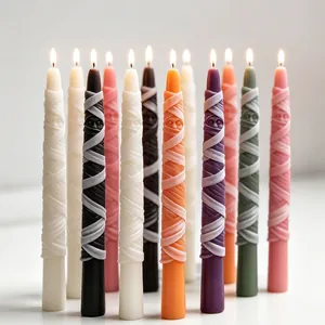 Close-up view of vibrant mummy-themed taper candles lit for festive Halloween home decor.