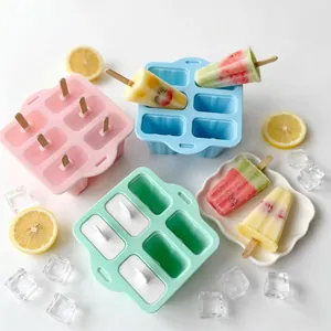 Detail view of colorful 6-cell silicone popsicle molds with fresh fruit ice bars and ice cubes