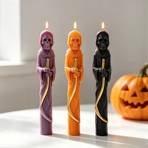 Set of three lit Grim Reaper skull candles in purple, orange, and black for Halloween.