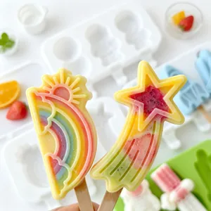 Close-up of vibrant DIY rainbow and star-shaped popsicles made with silicone molds