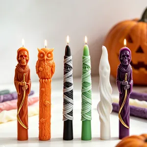 Detailed macro view of decorative Halloween long taper candles with spooky character designs