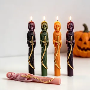 Detailed view of colorful reaper skull long candles with golden scythes for Halloween