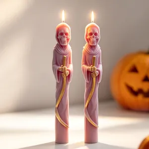 Detailed view of two lit pink grim reaper skull candles for creepy Halloween decor