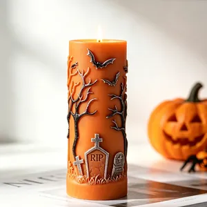 Detailaufnahme einer orangefarbenen Halloween-Kerze mit Fledermäusen und Grabmälern