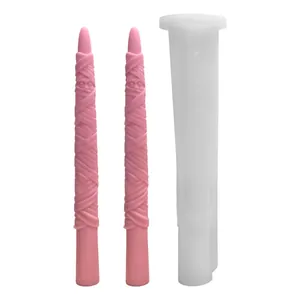 Halloween mummy long taper candle silicone mold with two finished pink wax samples