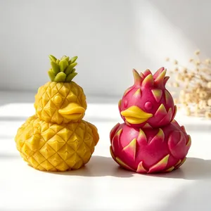 Detailed view of creative pineapple and dragon fruit duck shaped scented candles