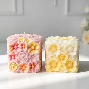 Macro detailed view of exquisite floral relief patterns on two square scented candles