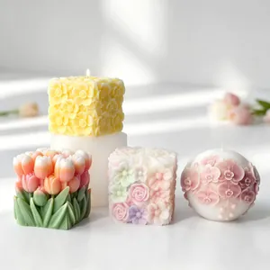 Detail of floral relief scented candles in square and sphere shapes with intricate textures.