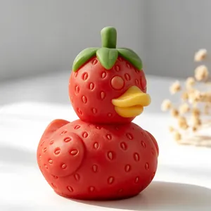 Detailed view of a red strawberry-shaped duck candle made from a silicone mold.
