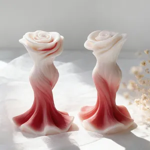 Vista macro detallada de elegantes velas aromáticas en forma de rosa con degradado rojo.